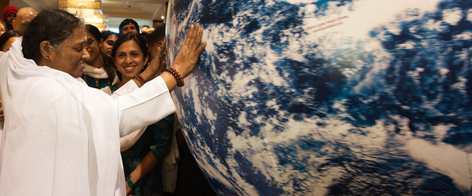 amma-compassion-touching-globe-hero-1536x640